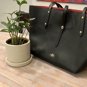 Black work bag with red lining that is perfect for to and from work.